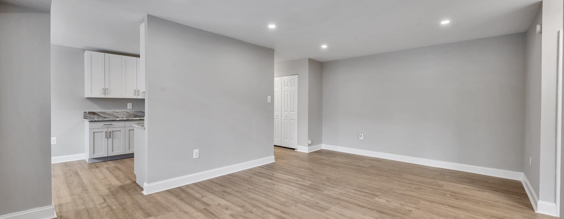 an empty living room with grey walls