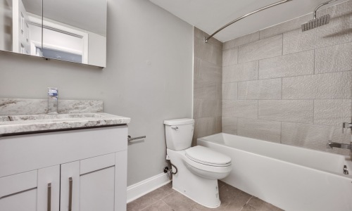 a bathroom with a shower, toilet and, mirror