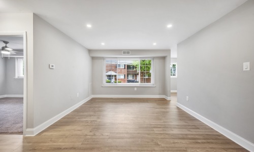 a living room with wood floors and a window