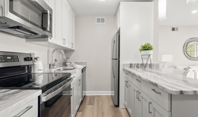 Renovated kitchen with quartz countertops at Sussex Square Apartments in Plymouth Meeting PA