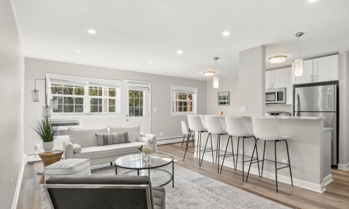 a living room with a couch and chairs