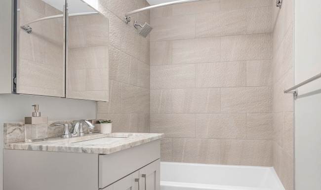 Updated bathroom with modern fixtures at Sussex Square Apartments