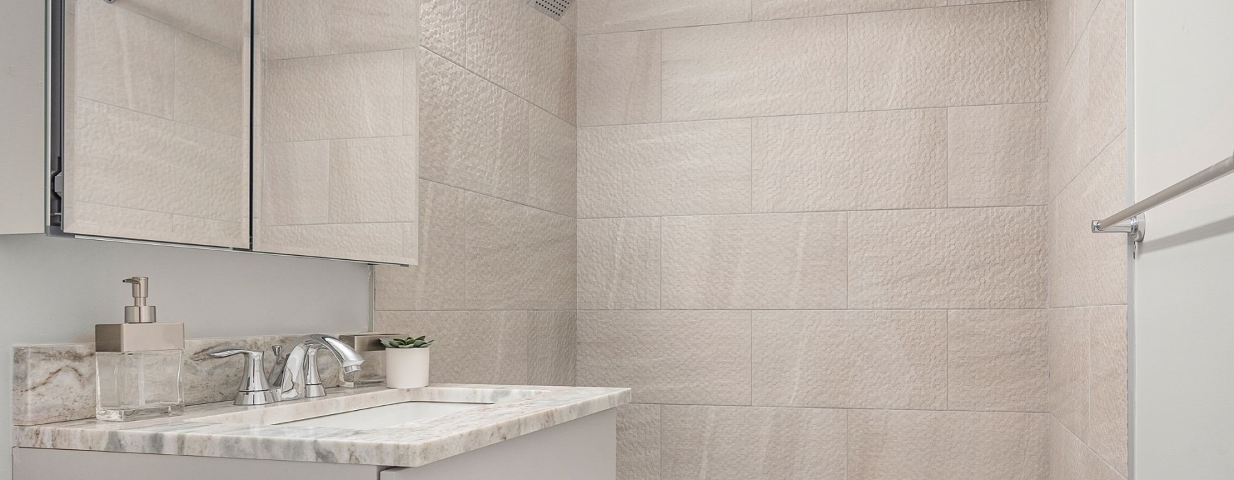 Updated bathroom with modern fixtures at Sussex Square Apartments